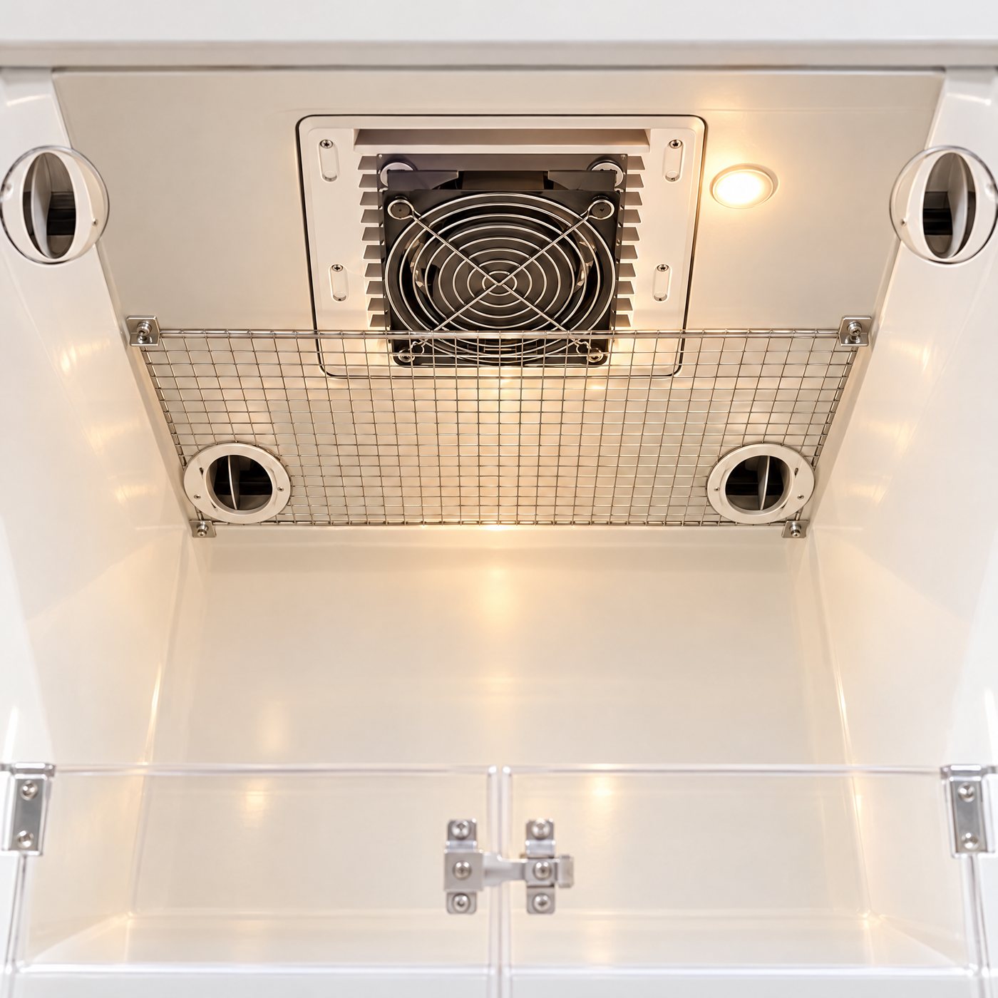 Looking up at the ceiling heater, fan and steel mesh guard inside the Kiba Nest