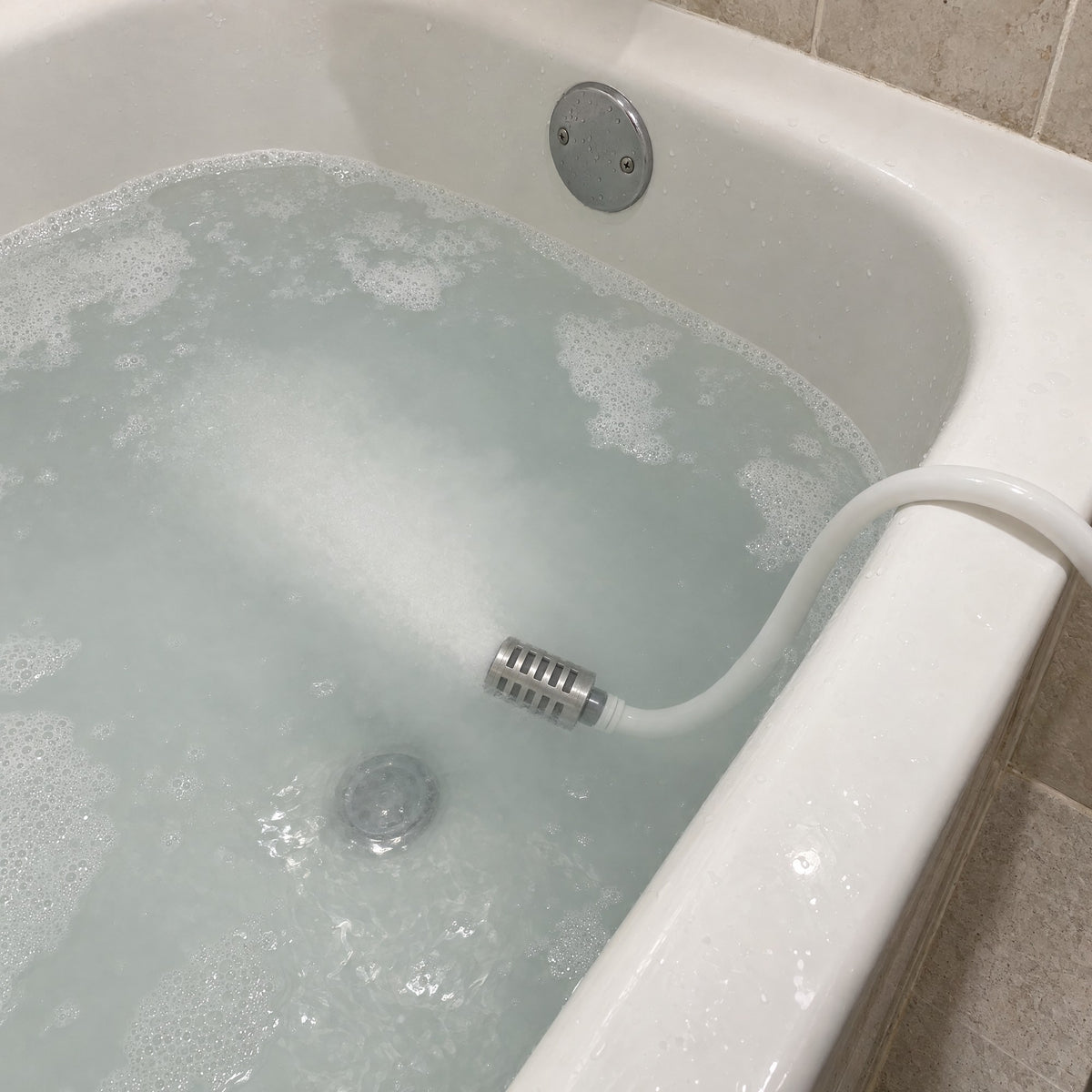The aerator head releasing a cloud of microbubbles into clear water